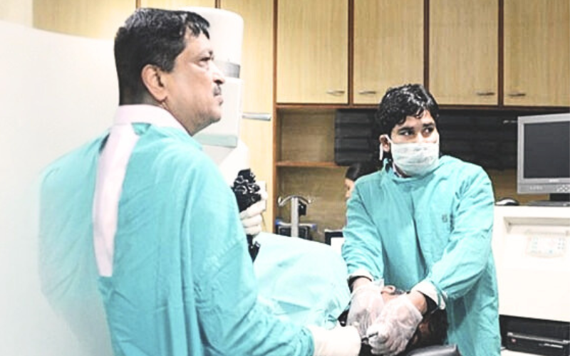 Medical professionals in surgical attire.